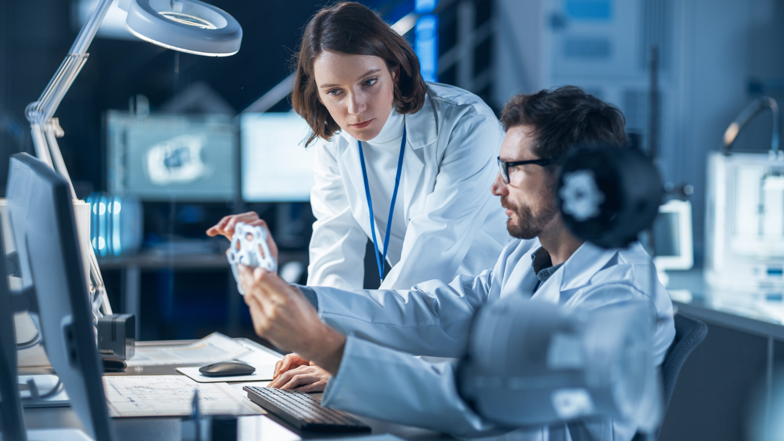 two engineers inspecting a medical device component